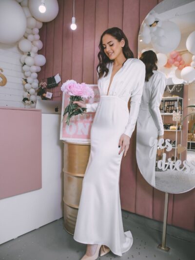 Stylish dress white with sleeves t deep neckline on grudi