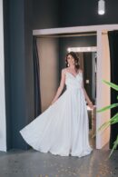 White dress made of dense satin with thin straps